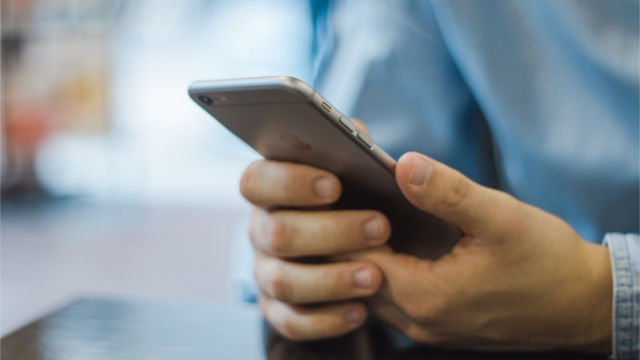 Hand holding mobile phone