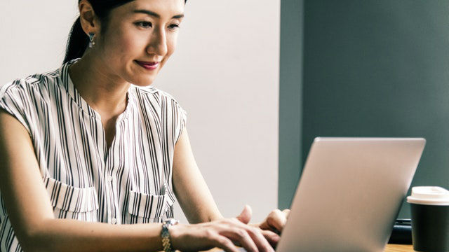 a girl is watching a computer