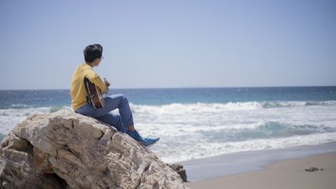 a Christian is playing the guitar