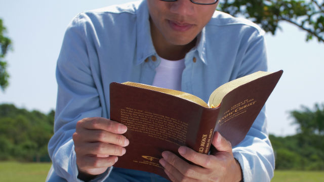 A Christian is reading a book