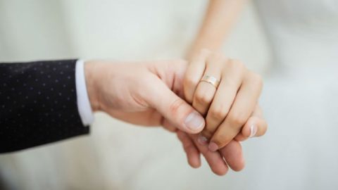 Two people holding hands