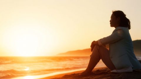 a frustrated woman sitting on the beach